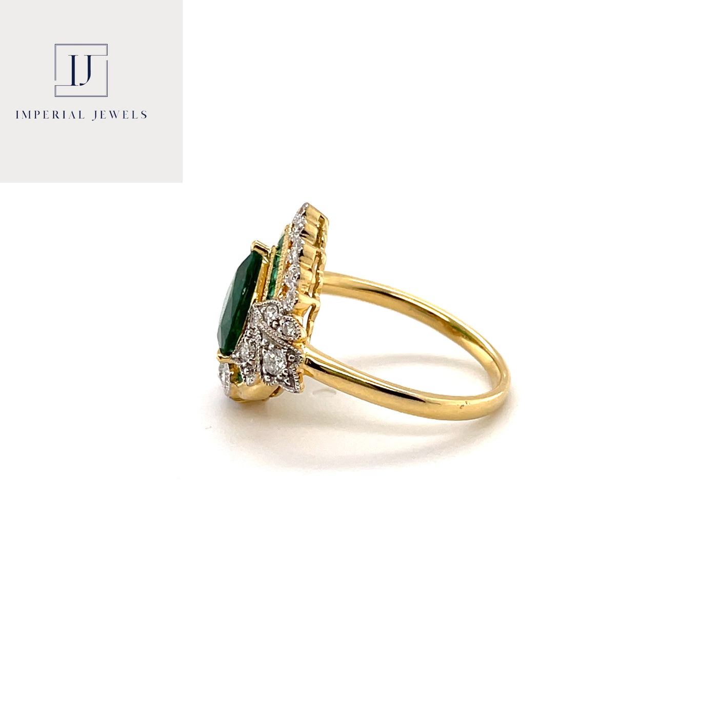 18CT yellow gold heart cut emerald and diamond ring